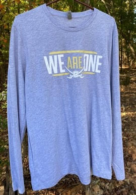 A blue t-shirt with white text on itDescription automatically generated with medium confidence